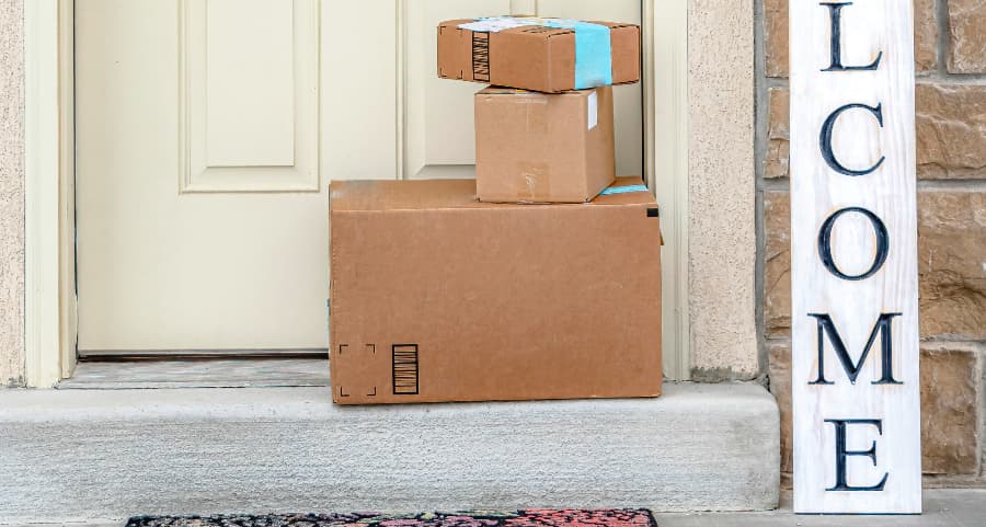 Packages on the doorstep of a home with a welcome sign in Decatur